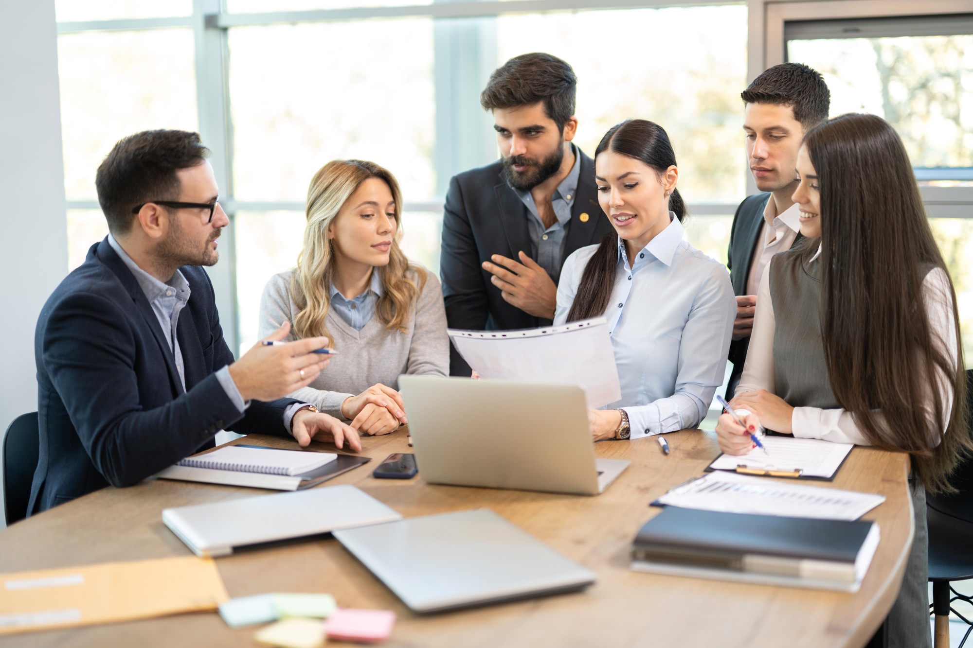 Corporate business group discussing paperwork on a meeting in office.